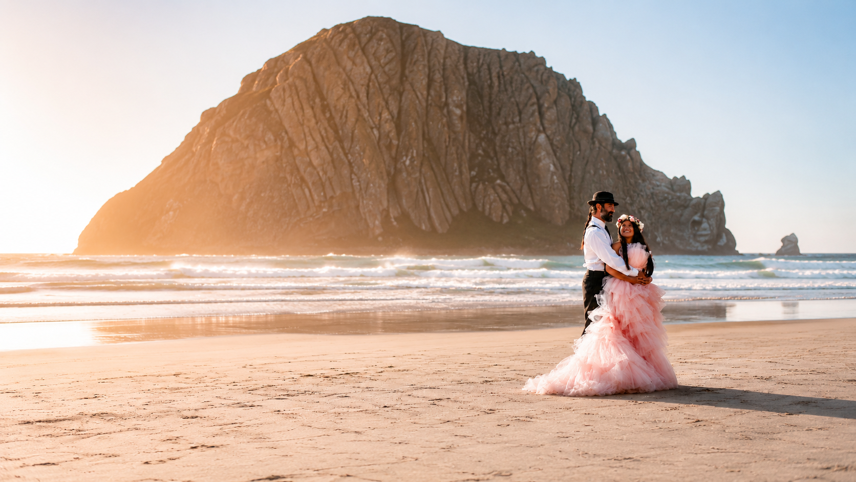 A couple embrace on the Oregon coast at golden hour